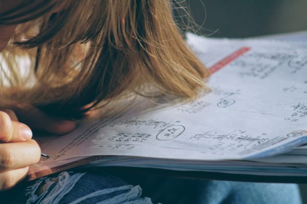 A frustrated student with his head on his notebook