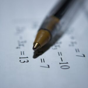 Close-up of pen on paper with equations for act math problems practice