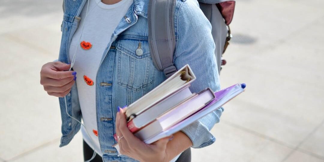Student with books in their hand