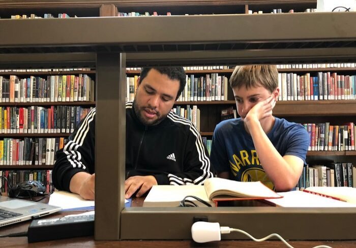 A math tutor tutoring a student for the summer math intensive