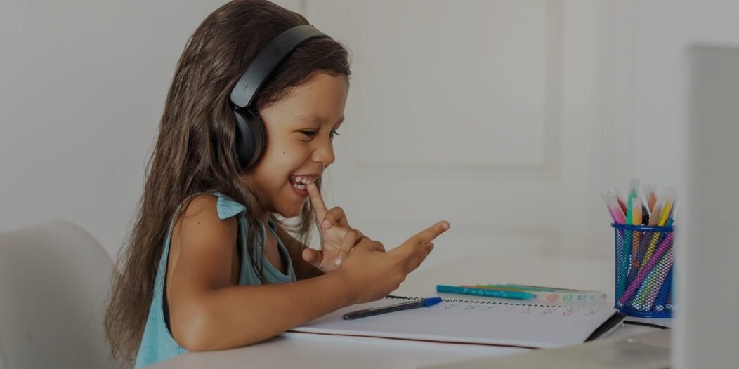 Girl on her laptop feeling happy about doing her school work