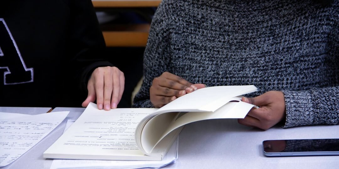 A student focusing on summer test prep goes through a workbook with her tutor.